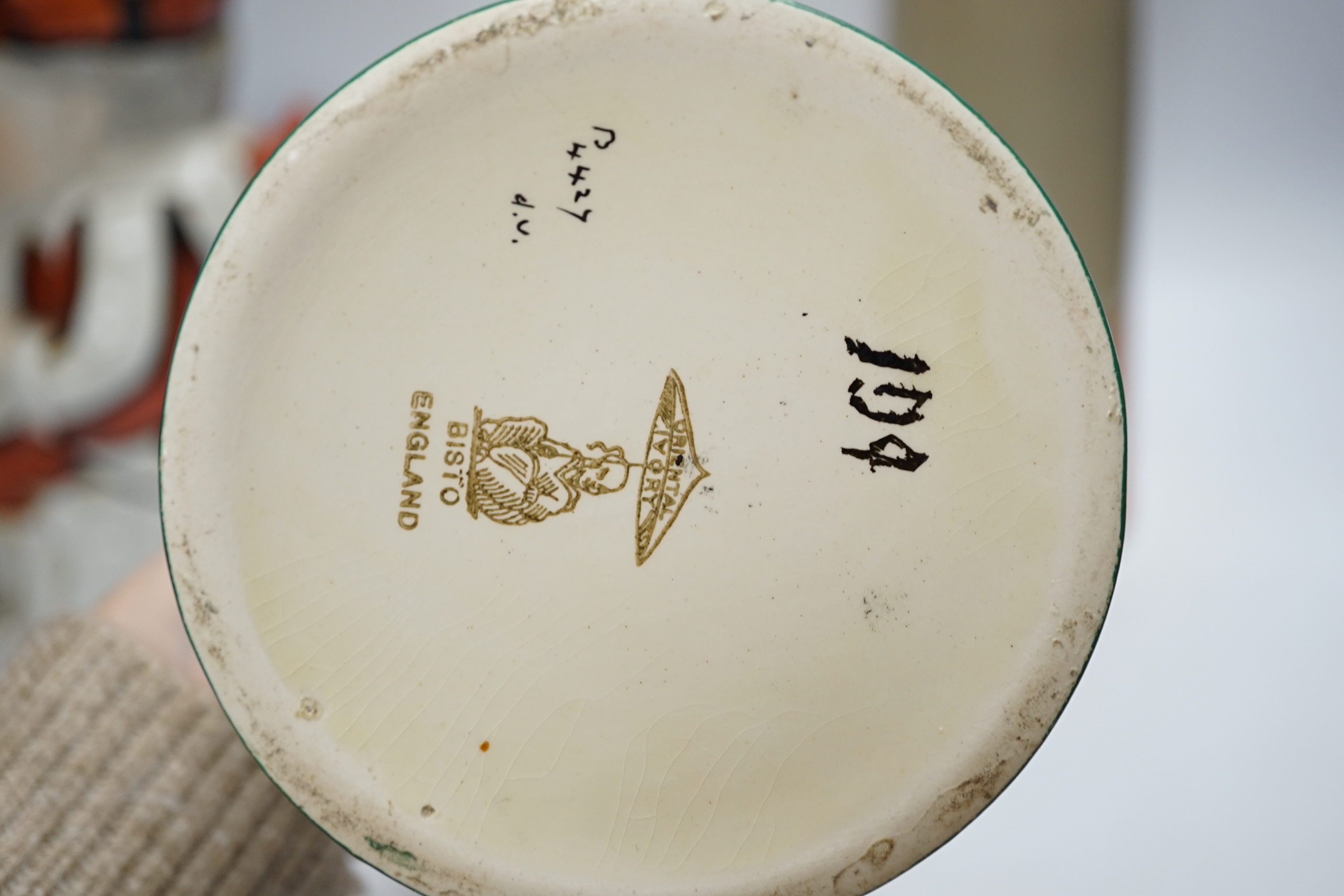 A Bisto jug, two other jugs, a Toby jug and a Quimper saucer, tallest 39cm